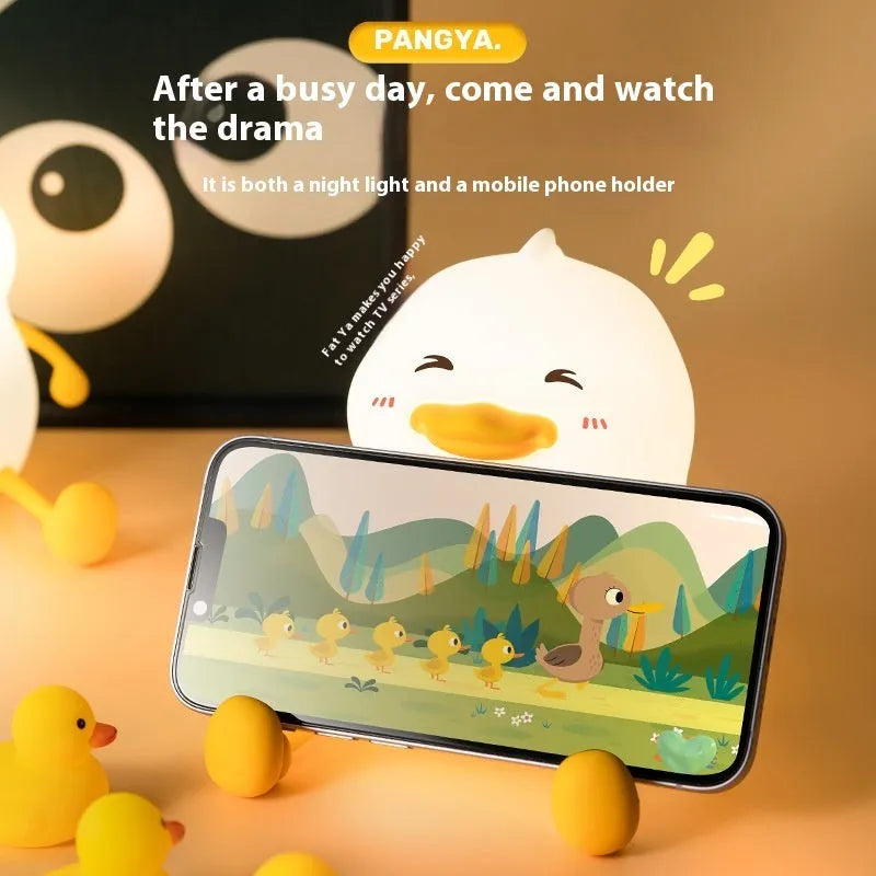 Chubby creative night lamp with phone holder function in silicone and plastic construction