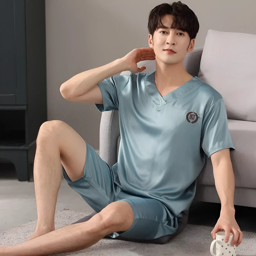 Man's light blue ice silk short-sleeve pajama shirt and loose matching shorts laid flat