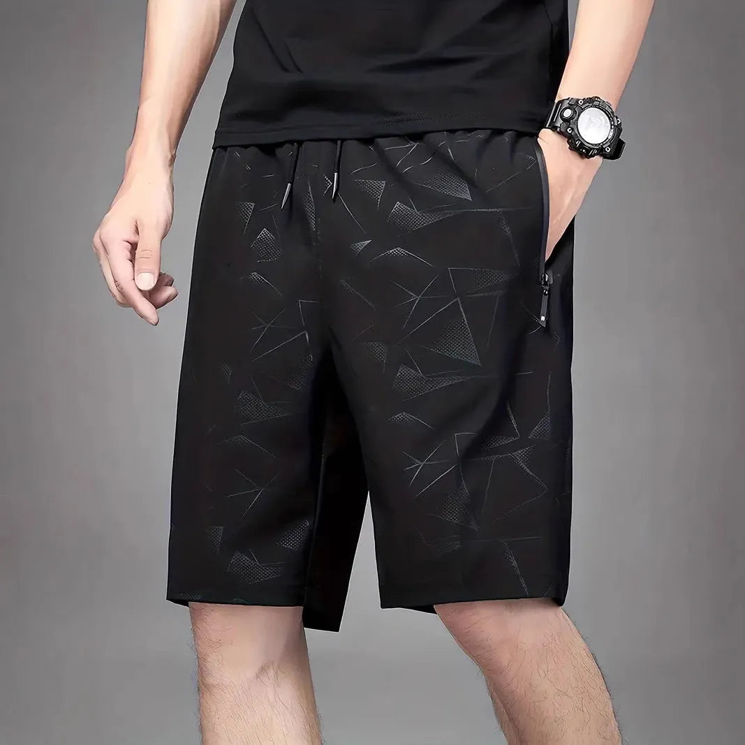 Men's loose-fit sports shorts in polyester with elastic waistband, available in black grey blue colours