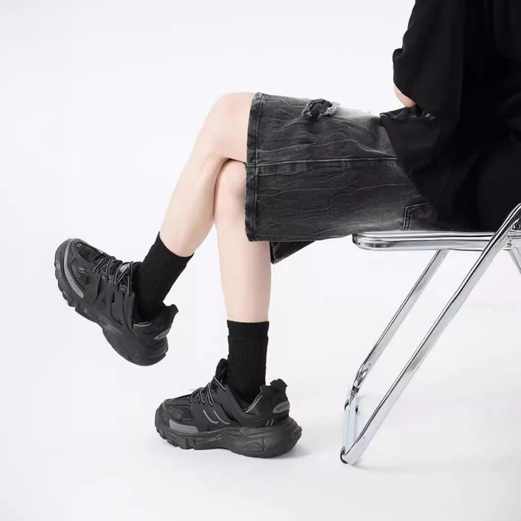 Women's washed denim shorts with ripped detailing in loose retro fit, shown in black and blue colour options