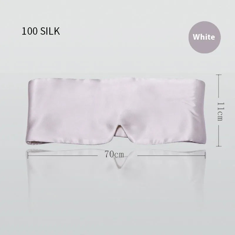 Mulberry silk sleep eye mask shown in champagne gold colour, laid flat on a surface.