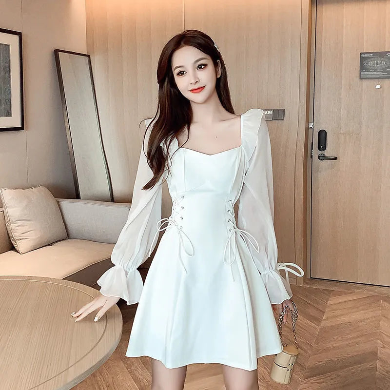 White long sleeve chiffon patchwork dress with a slim waist and floor-length skirt on a woman.
