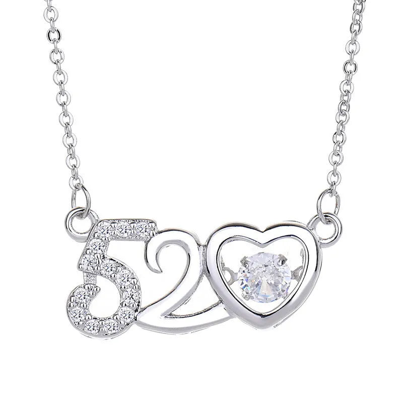 Silver heart pendant necklace with small crown and bow charms on a delicate chain.