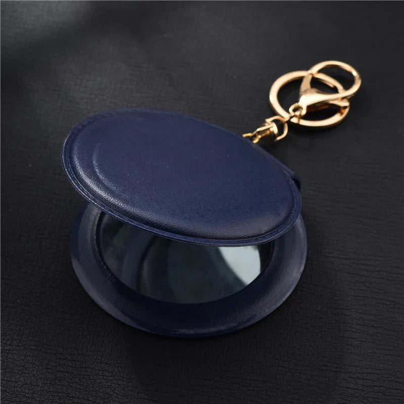 Compact round ladies leather makeup mirror with 8cm diameter glass surface and golden buckle