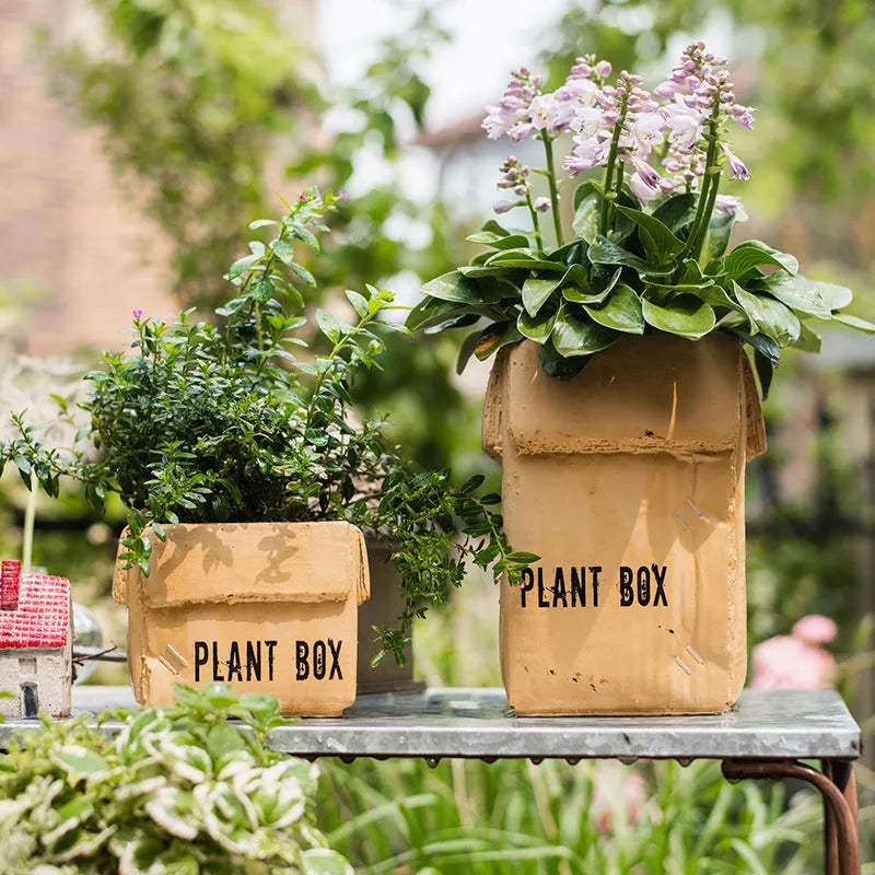Cement brown paper box style flowerpot with a drainage hole, shown in a Nordic interior setting.