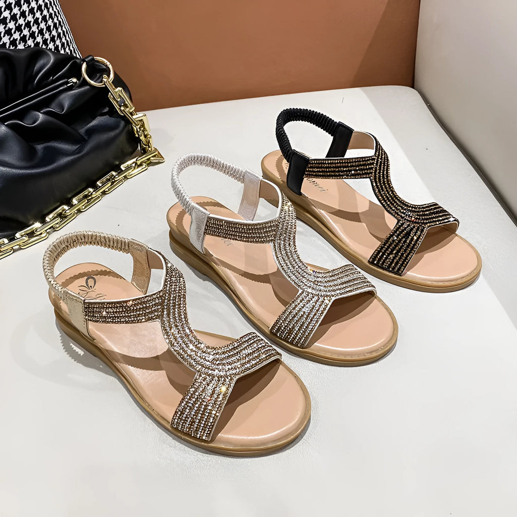 Women's patent leather beach sandals with rhinestones on a round toe, shown in gold colour.