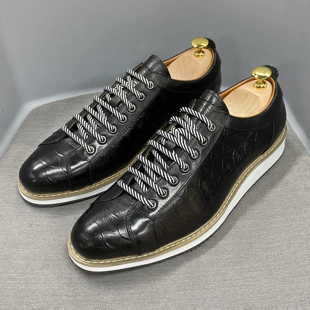Men's low-top handmade casual shoes with an embossed pattern and front lace closure.