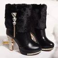 Women's black chunky high heel ankle boot with a pointed toe, made from artificial PU leather.