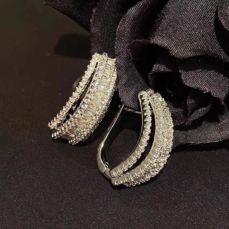 Geometric zircon stud earrings in white gold colour with copper construction