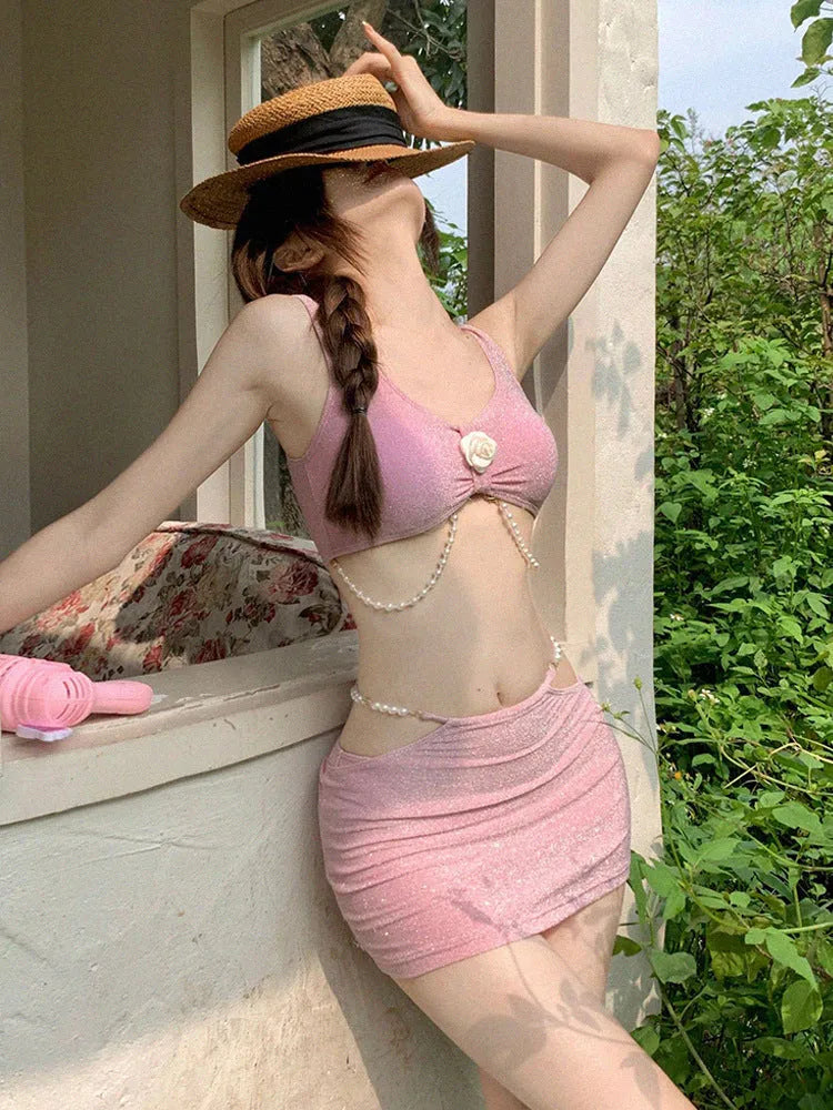 Women's pink and black three-piece bikini swimsuit set with briefs, made from high elasticity polyester fabric.