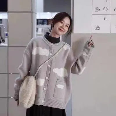 Blue women's cardigan with white cloud pattern, loose fit and long sleeves.