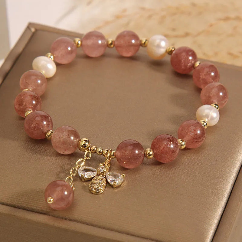 Women's bracelet with freshwater pearls, strawberry quartz stones, zircon accents and alloy bee charm