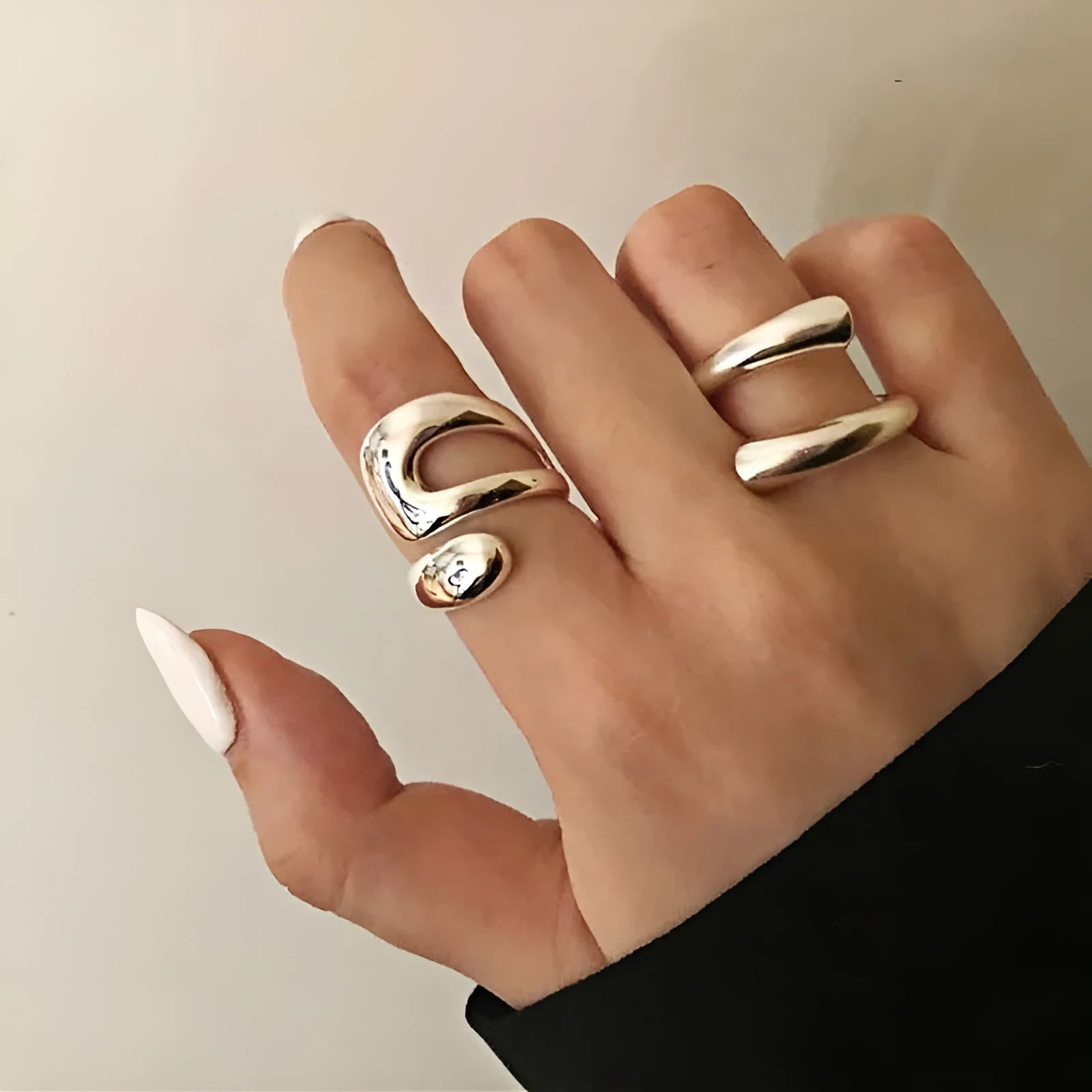 Silver tone adjustable geometric open ring with heart motif on a white background