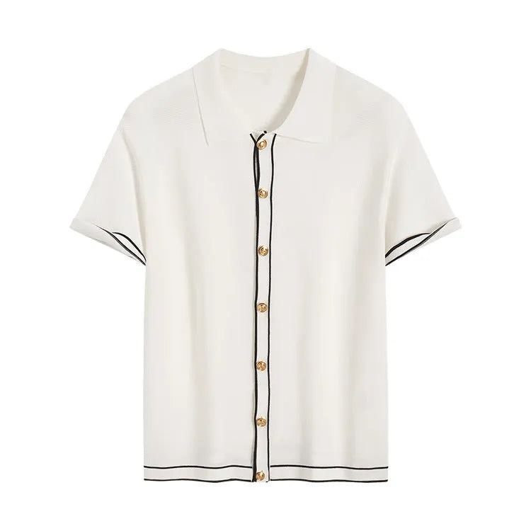 White women's short sleeve cardigan with dark contrast colour lapels on a hanger.