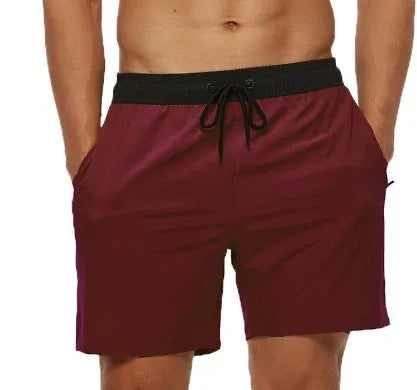 Men's blue running shorts with a stitching waistband, drawstring, and a side zippered pocket.