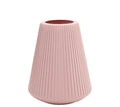 White melamine plastic decorative flower vase measuring 16cm by 20cm on a desktop