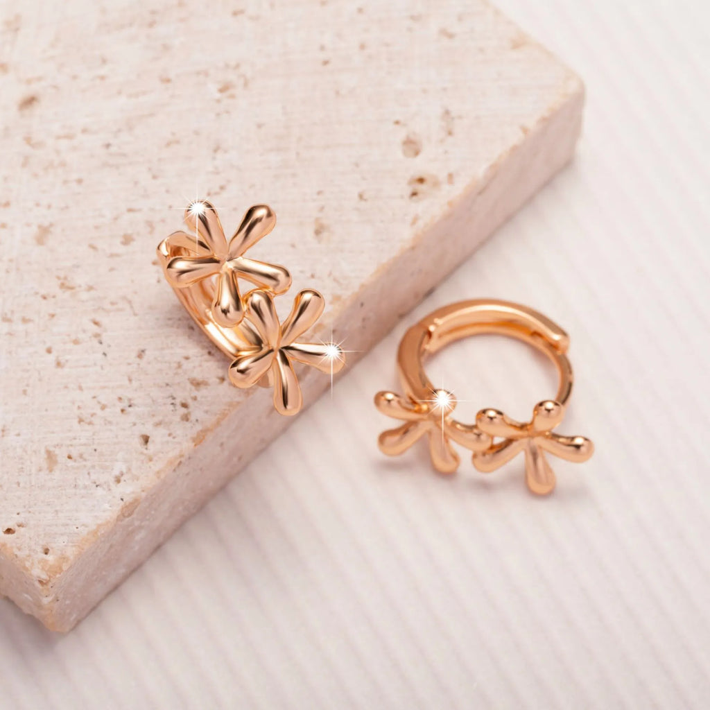 Rose gold circular earrings with a waterdrop flower design for women.