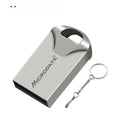 Silver car-shaped metal USB flash drive on a chain, shown next to a laptop.