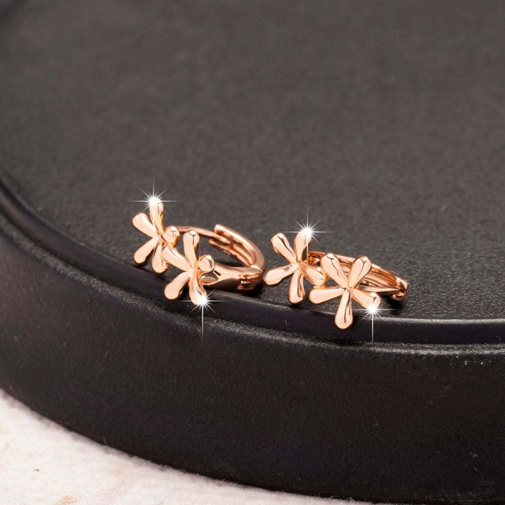 Rose gold circular earrings with a waterdrop flower design for women.