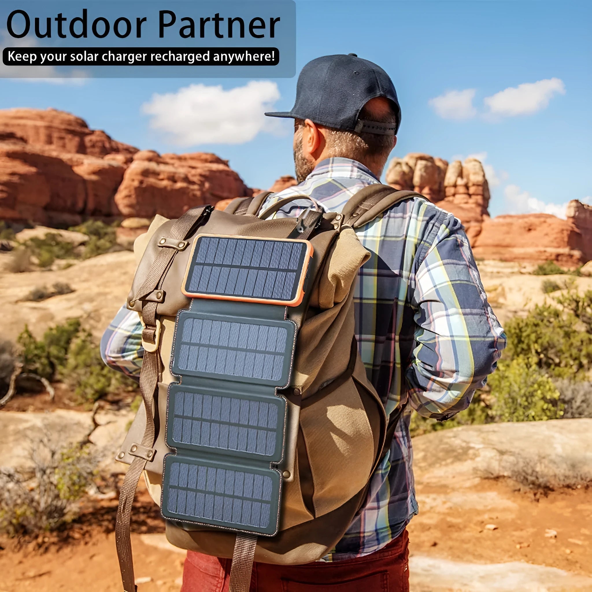 Black solar power bank with a solar panel, showing its USB ports and LED light, placed outdoors on a rock.