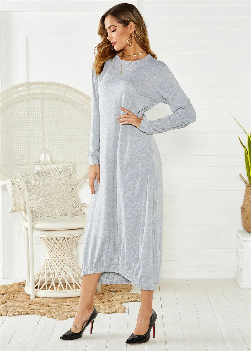 Loose-fitting black lantern dress with a crew neck and lace-up front detail on a mannequin.