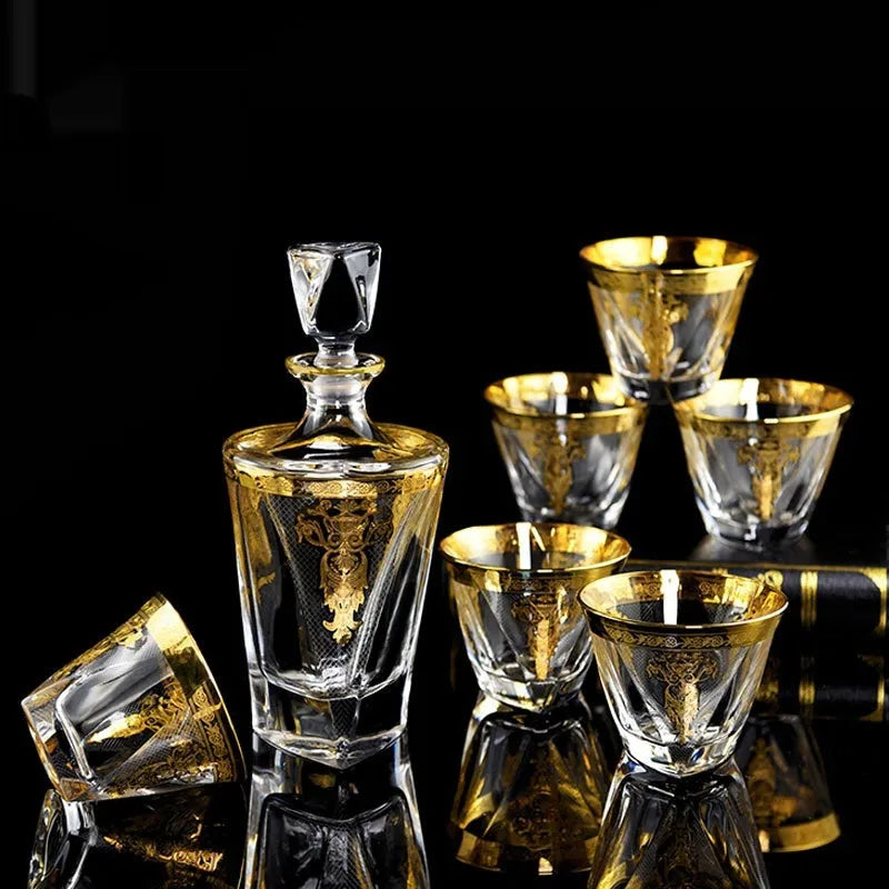 Gold line crystal glass whisky tumbler set with wine bottle and six glasses on a table