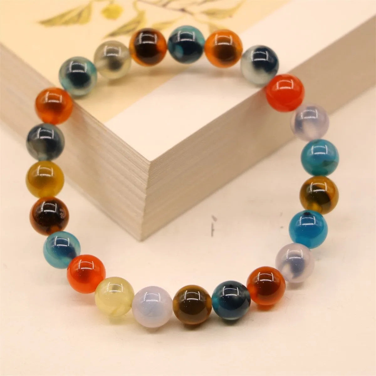 Women's agate bracelet with copper coin snake chain and coloured glaze detailing in geometric bead design