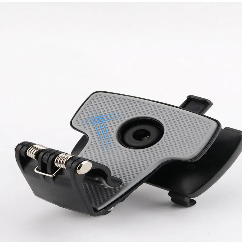 Black car phone holder mounted on dashboard with smartphone in clip