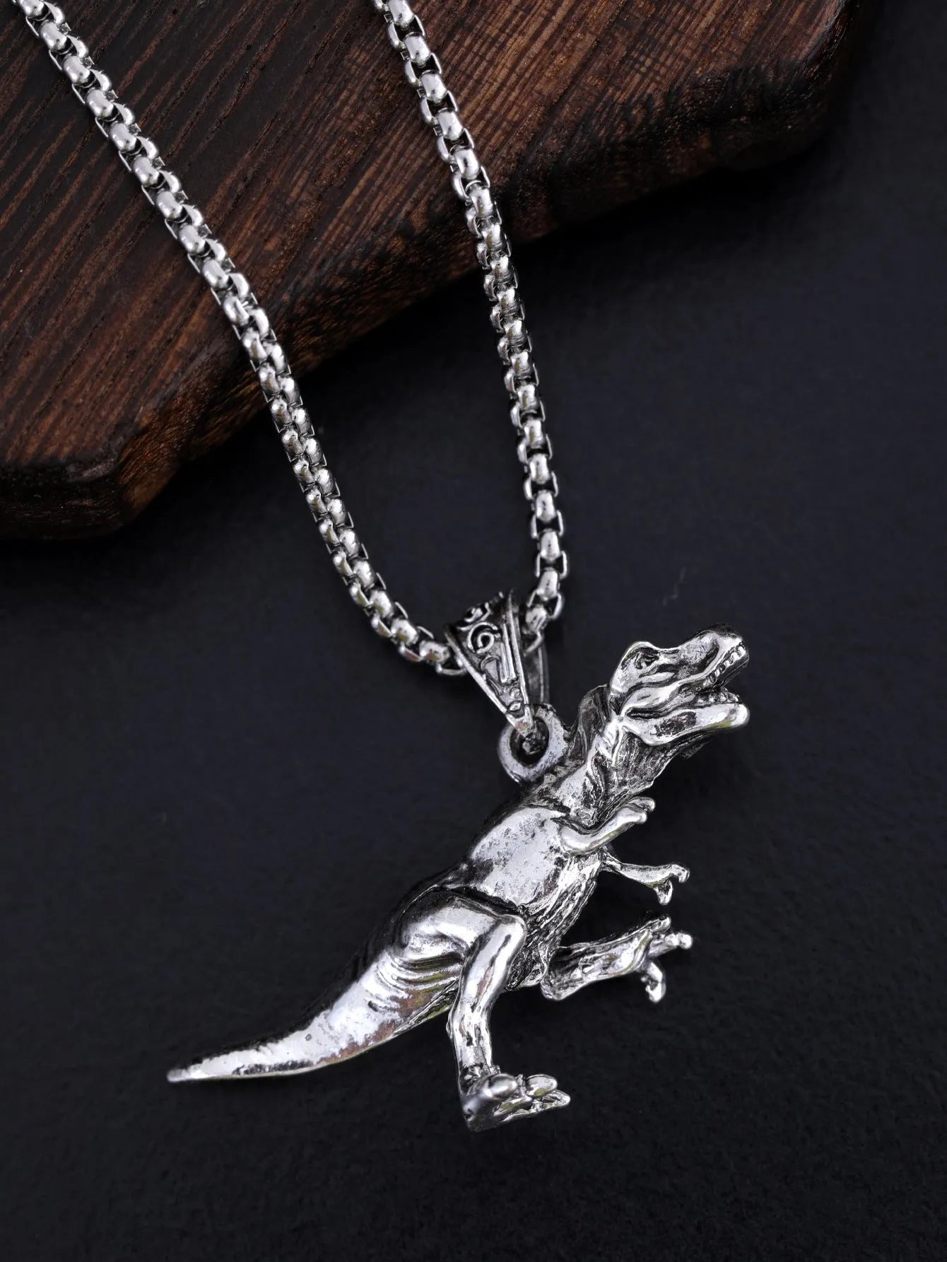 New hip hop style versatile titanium dinosaur pendant in silver tone on a neutral background