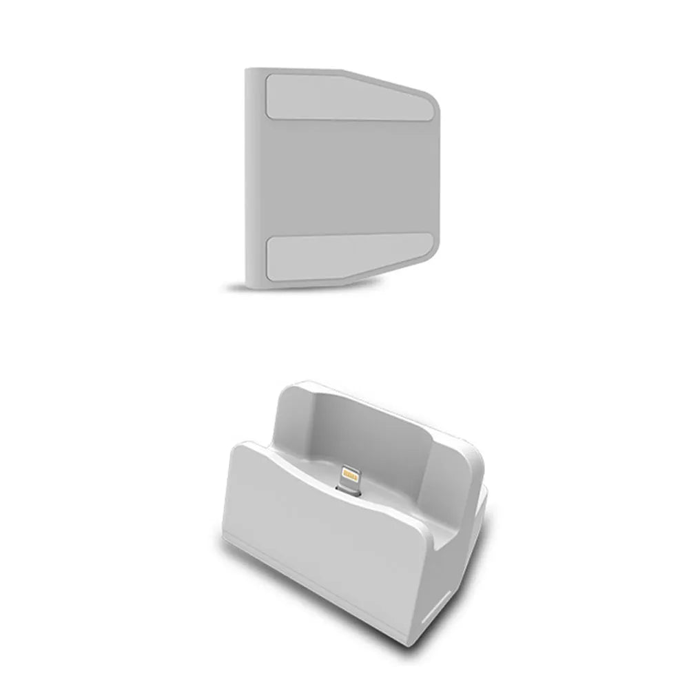 White headphone charging base stand on a desktop holding a gaming headset