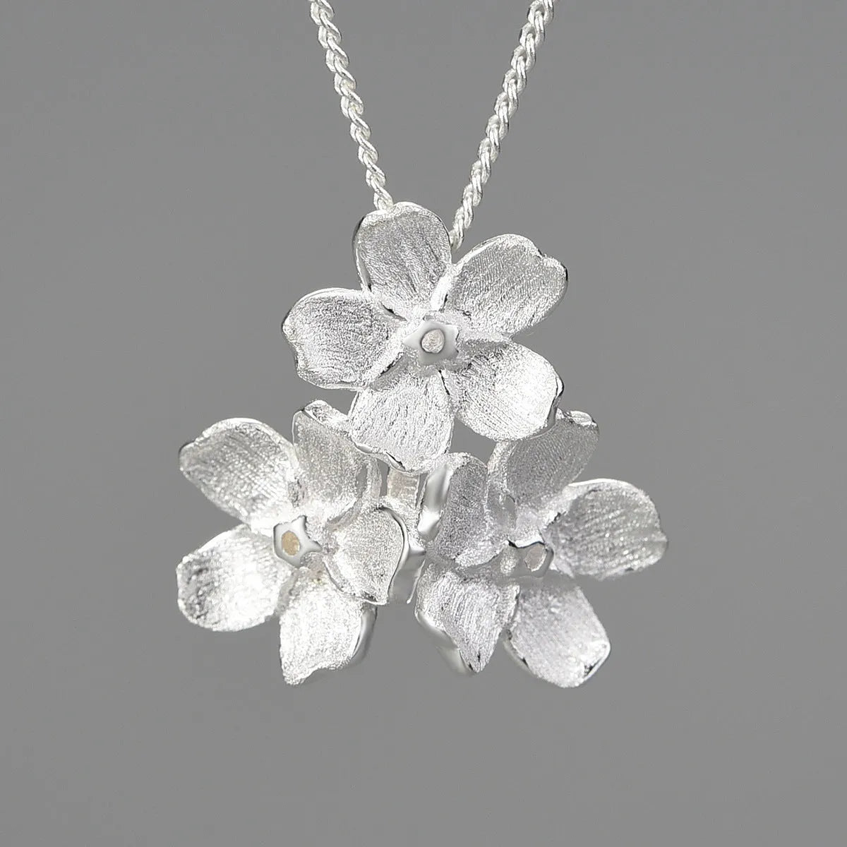 Myosotis Sylvatica sterling silver flower pendant with electroplated finish and hand-designed botanical details
