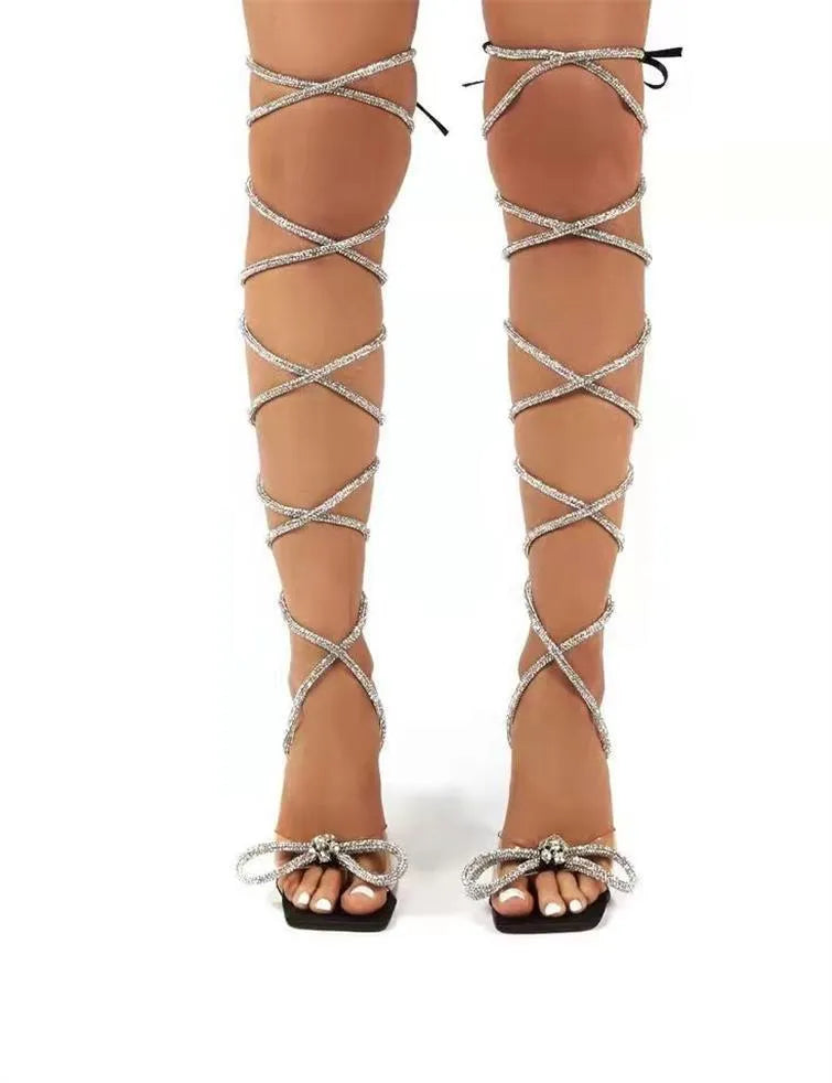 Plus size women's black strappy sandals with Roman rhinestone strap detail and square toe.
