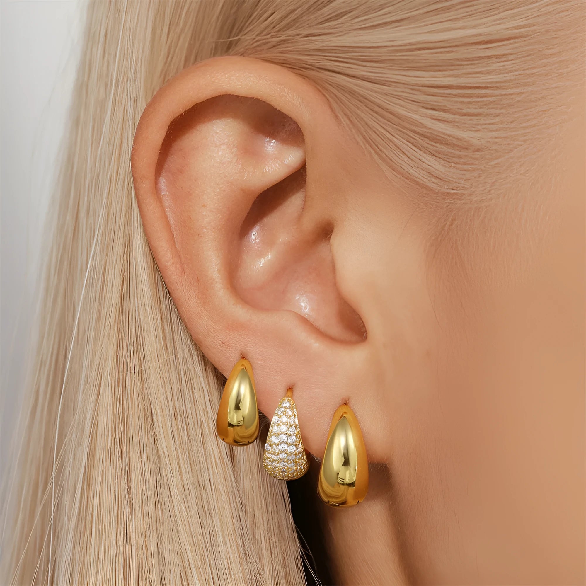 Golden brass earclip earrings with geometric shapes and round elements