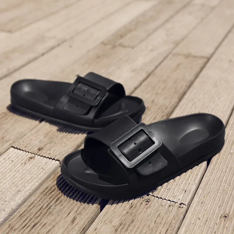 Women's grey blue EVA buckle slippers showing buckle detail and textured sole