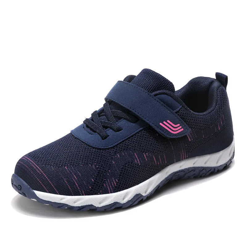 Women's grey purple low-top casual shoes with Velcro strap and wedge heel on a plain background.