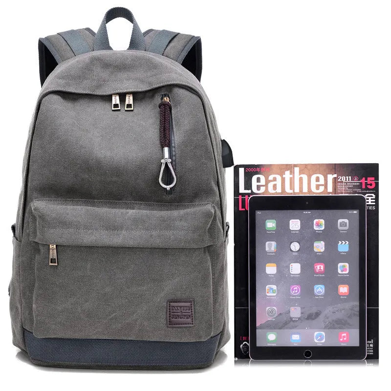Canvas backpack with USB charging port showing laptop compartment and multiple pockets