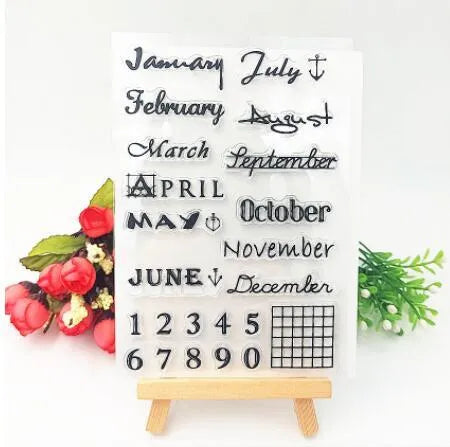 Close-up of a transparent silicone craft stamp featuring vintage-style calendar icons on a digital table background.