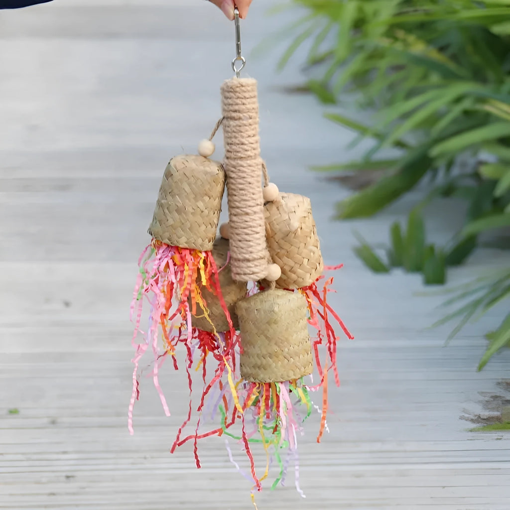 Colourful shredded paper parrot toy with wood and sisal construction measuring 15 by 35 centimetres