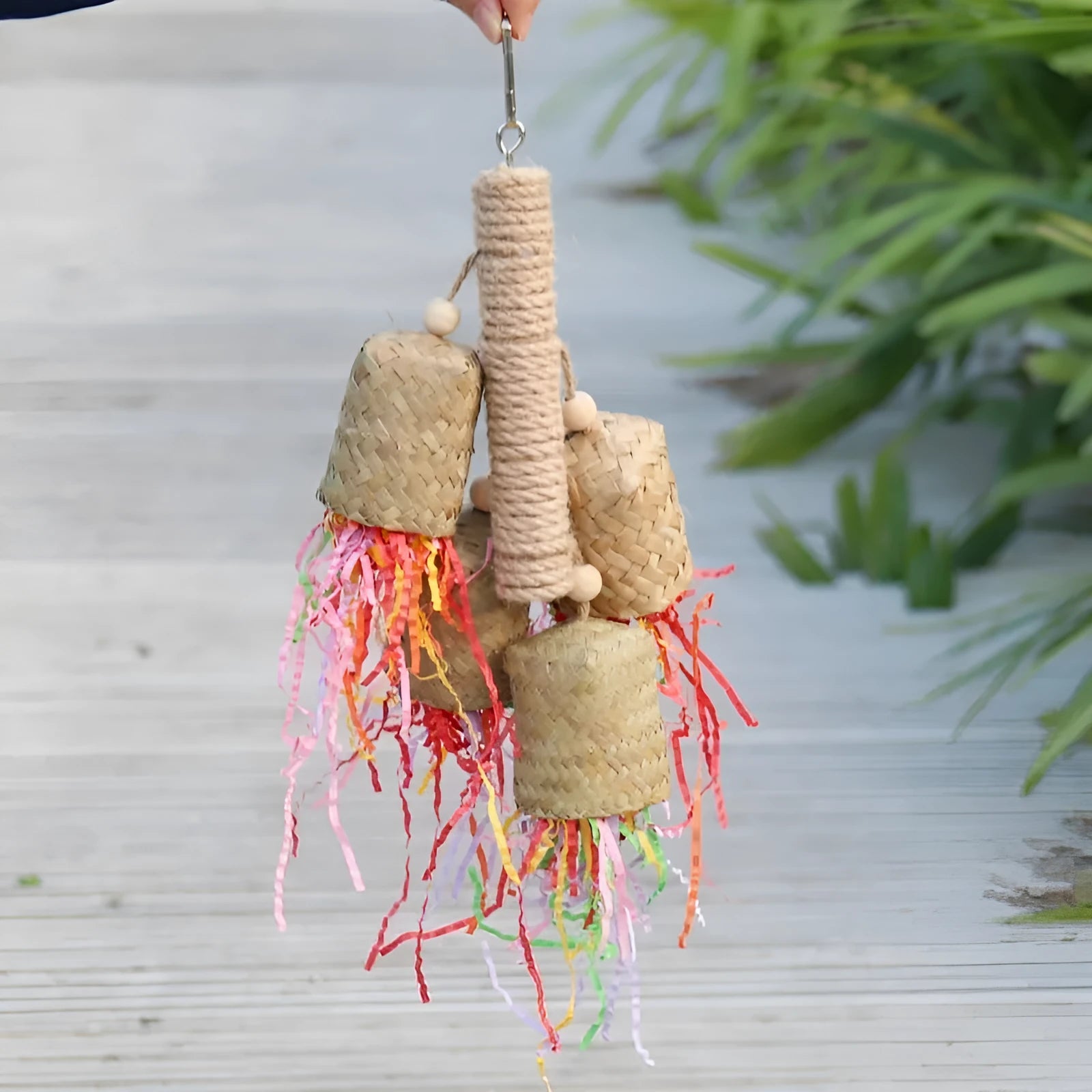 Colourful shredded paper parrot toy with wood and sisal construction measuring 15 by 35 centimetres
