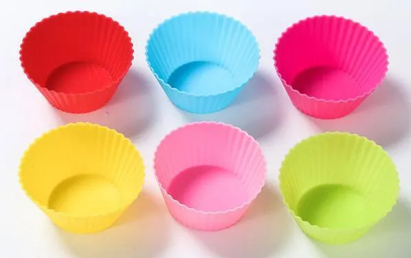 12 nonstick reusable silicone cupcake liners in six colours arranged for baking