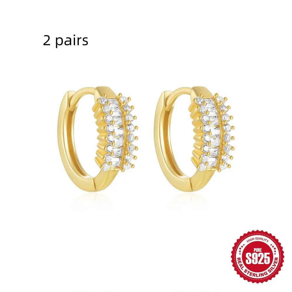 Sterling silver geometric stud earrings with round diamond accents in gold and silver electroplated finishes