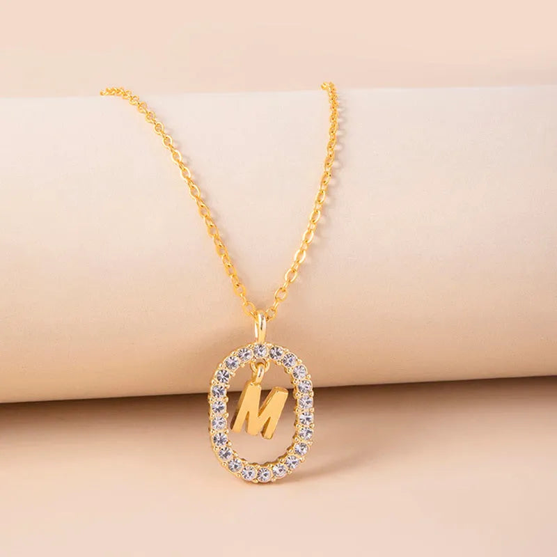 Gold crystal letter initial oval pendant necklace on woman, rhinestone letter in zinc alloy frame with adjustable chain