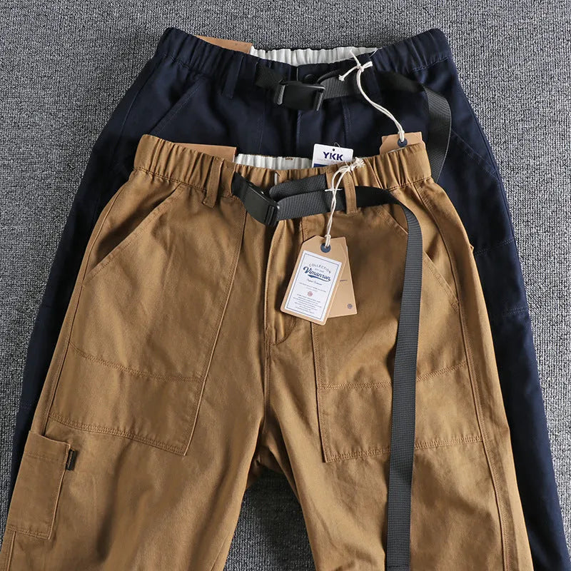 Men's khaki cotton work trousers with an adjustable N-I buckle belt on the waistband, shown with a 3D cut design.