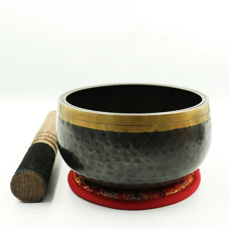 Black and gold copper sound bowl with Buddha design on thin pad, 12.5cm calibre
