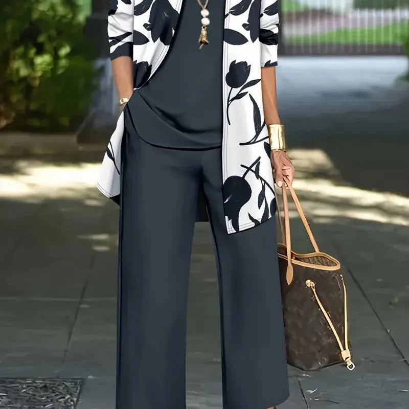 Women's blue three-piece casual suit comprising a long-sleeve coat, a vest, and trousers on a hanger.