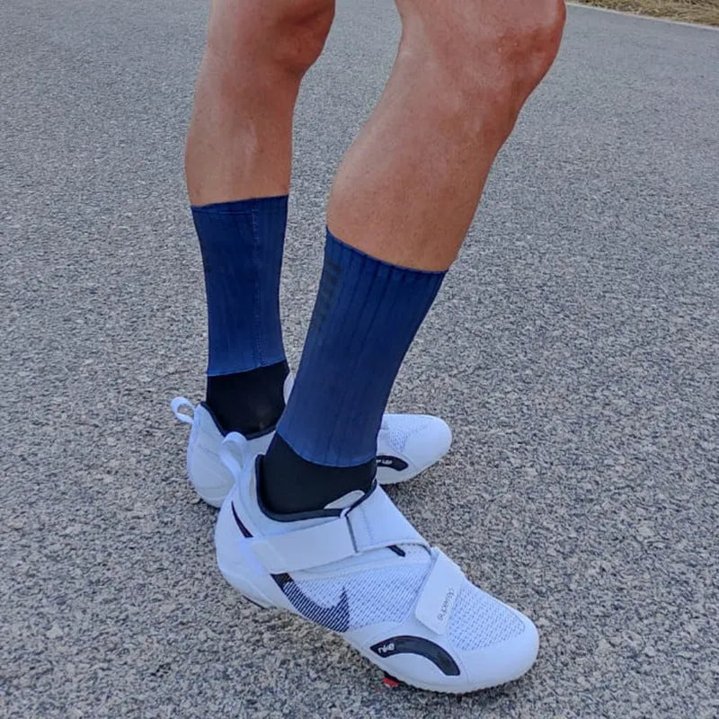 Cycling socks in chemical fibre blend fabric shown in orange, black, purple, white, grey and dark blue colour options