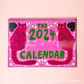 Cat calendar wall planner showing monthly grids with feline illustrations on A4 paper