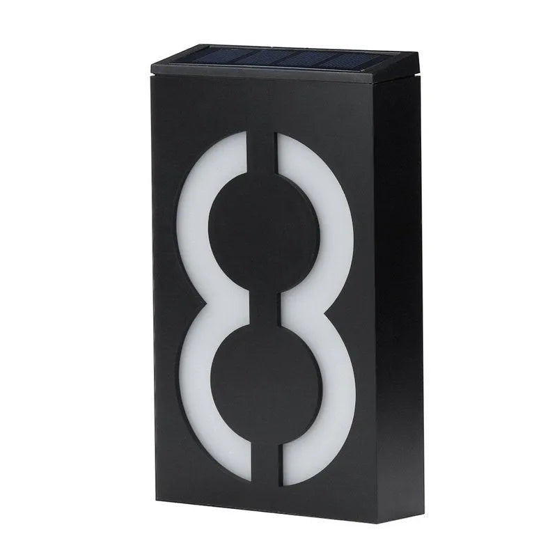 Solar powered outdoor house number light with white LEDs and wall mount.