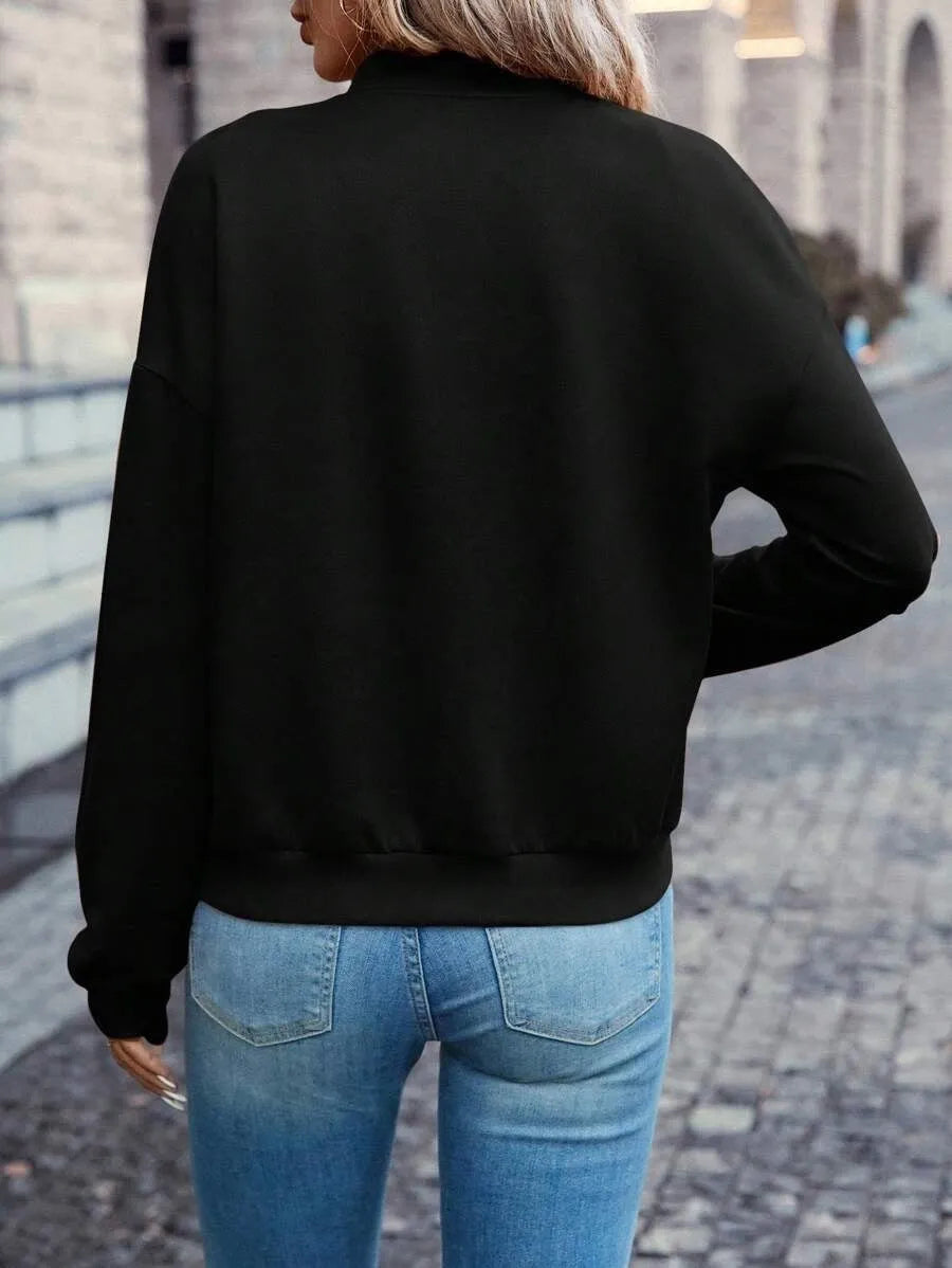 Black women's casual zip-up jacket with long sleeves and faux pockets on a hanger.