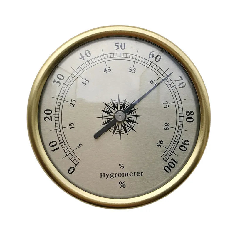 Analogue thermometer and hygrometer with aluminium dial on a white wall.